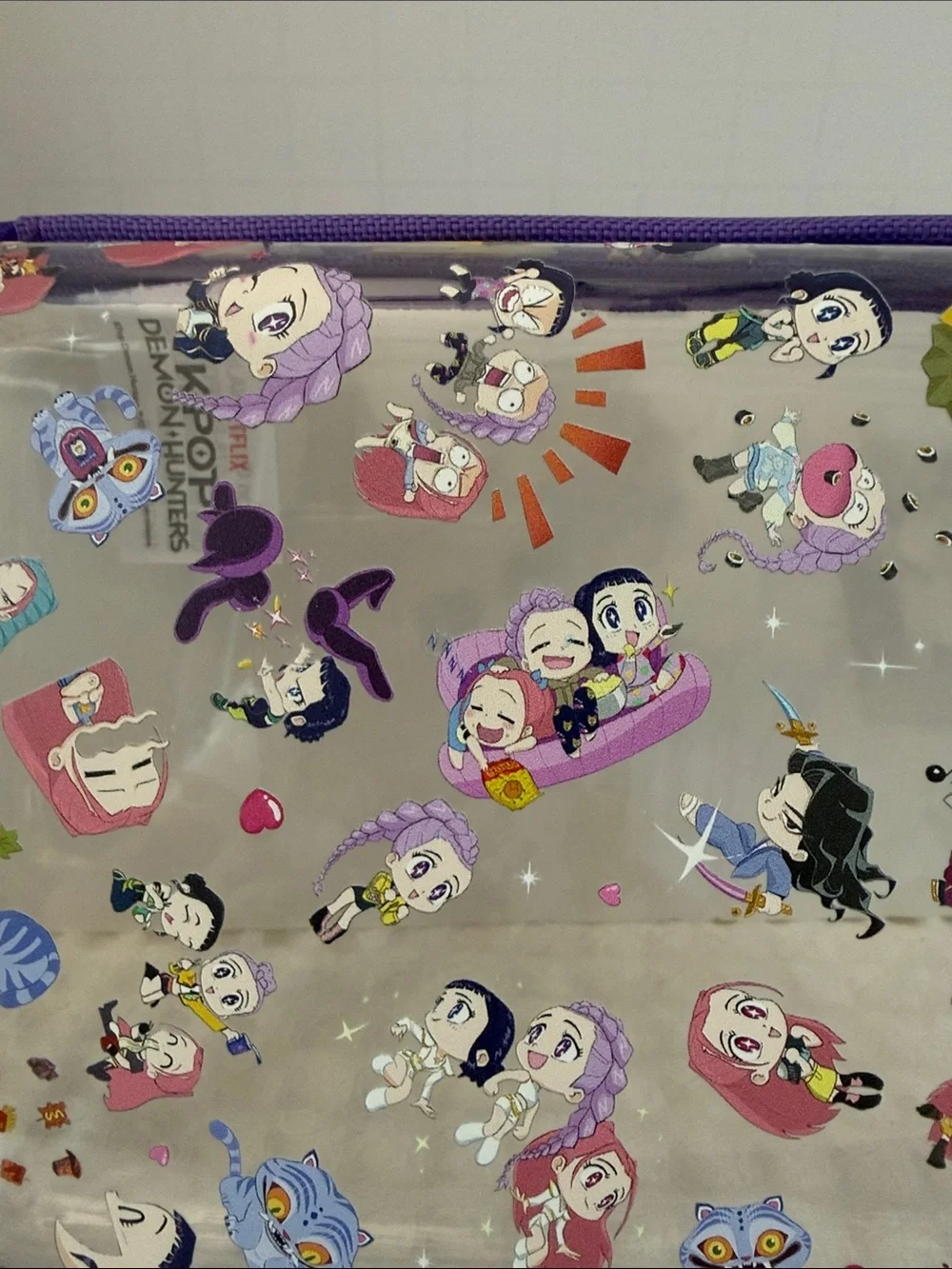 Netflix K-POP Demon Hunters Chibi-Style Clear PVC Pencil Case with Purple Trim.